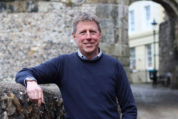 James MacCleary standing in front of the entrance to Lewes Castle and looking very relaxed.